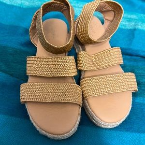 Very gently worn wedge in a stretchy tan strap color